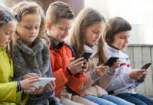 Children busy on smartphones. The use of technology, embedded on smartphones, Tablets, iPads and Computers has been on the rise among children. Parents should be concerned about what their children are accessing online. Photo/iStock
