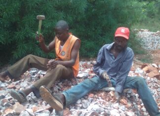 Charles Ouma, needy university student working fingers to the bone to raise fees Charles Ouma, a Moi University student (left) in orange jacket and his dad (John Origi) in red cap, crushing concrete at a quarry site in Budalangi, Busia County, to raise money for fees. Despite the efforts, he has been unable to get the fees and appeals to people of goodwill to chip in and help him out. PHOTO/Gilbert Ochieng, The Scholar Media Africa.