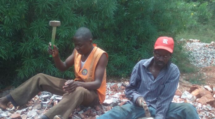 Charles Ouma, needy university student working fingers to the bone to raise fees Charles Ouma, a Moi University student (left) in orange jacket and his dad (John Origi) in red cap, crushing concrete at a quarry site in Budalangi, Busia County, to raise money for fees. Despite the efforts, he has been unable to get the fees and appeals to people of goodwill to chip in and help him out. PHOTO/Gilbert Ochieng, The Scholar Media Africa.