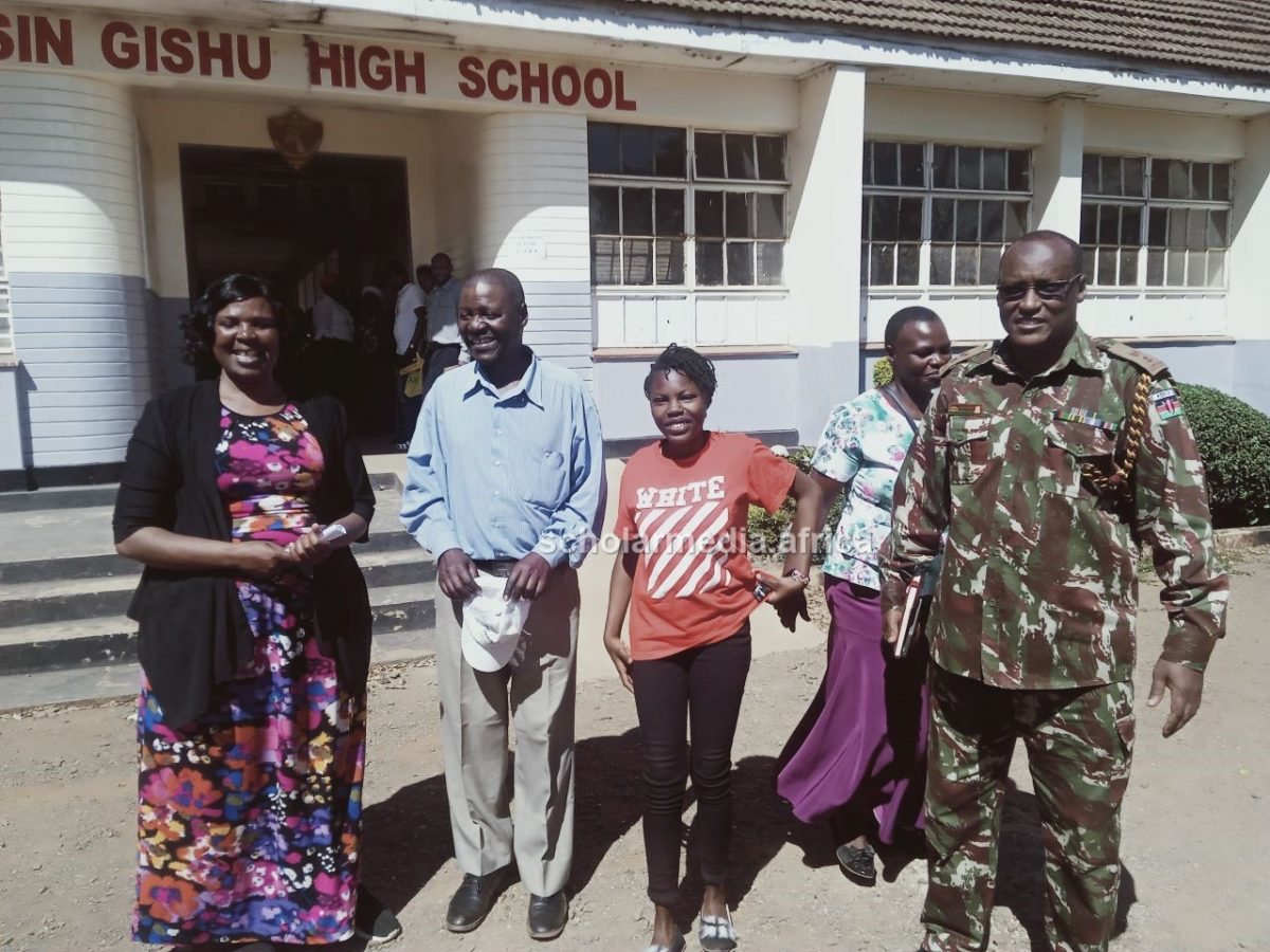 Awuor posing for a photo with her principal, parents and the subcounty security personnel. PHOTO/Edmond Kipngeno, The Scholar Media Africa.