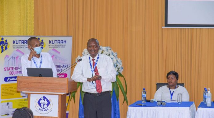 HEALTH: Hidden hope in overcoming cancer, a survivor’s story Evans Machera (center), a Nairobi-based city lawyer, addressing the First KUTRRH Annual Health Conference 2022 at the Kenyatta University Teaching, Referral & Research Hospital, two years after undergoing successful chemotherapy sessions at the health facility. PHOTO/Courtesy.