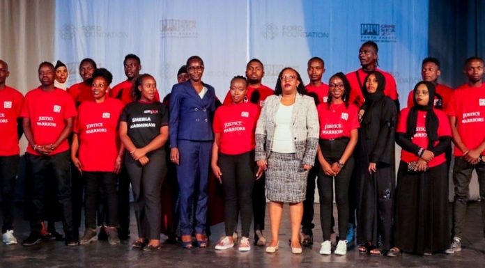 CRIME: Community Paralegals graduate ready to abate crime, step up justice Elizabeth Marube of National Police Service (in blue) and Zainab Abdul, a Principal Magistrate, pose for a photo with graduands during a community paralegals graduation at Sarakasi Dome, Nairobi, courtesy of Sheria Mashinani Initiative. PHOTO/Crime Si Poa (CSP).