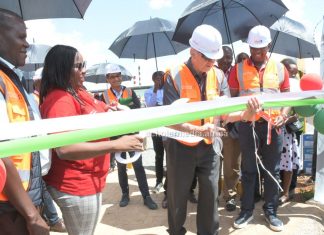 Sasini Group adopting green energy, phasing out electricity use Sasini PLC Chairman Mr. Jim McFie cutting the ribbon to commision the Kipkebe Solar Power Project during the event. PHOTO/Dan Nyamanga, The Scholar Media Africa.