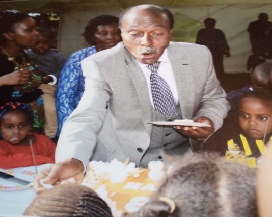 Prof. Ngugi: Rethinking CBC, academic philanthropy and stakeholder reinvention Professor David Ngugi, shares a piece of cake with his grandchildren on his 80th Birthday celebration. PHOTO/Courtesy.