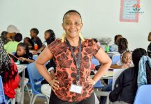 Dr. Carol Chakua having a moment with the kids at Stawi Camp for Wellbeing. Teaching youngsters on sex issues and reproductive health builds their knowledge base and helps them make the right decisions concerning their bodies and psychological wellbeing. PHOTO/Courtesy.