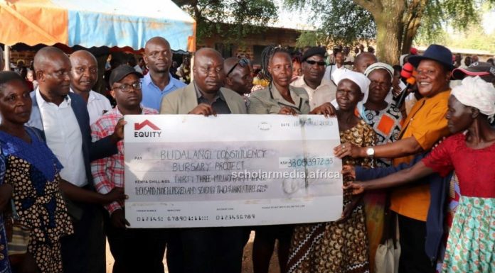 Thousands of Budalangi’s needy students to benefit from bursaries Raphael Wanjala (in orange shirt), MP Budalangi Constituency, presenting a cheque worth KSh33m for education bursary in Budalangi recently. PHOTO/ Gilbert Ochieng, Scholar Media Africa.