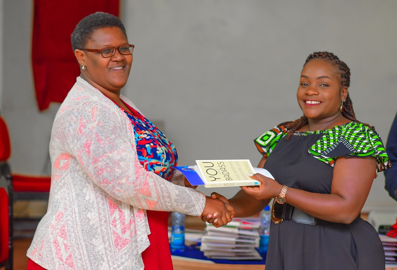 A participant receives her certificate and accompaniments from Dr. Orina (right). PHOTO/Arise Circle. 
