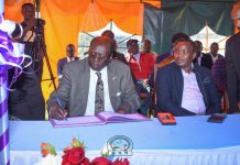 Barnabas Benjamin, Minister for Presidential Affairs of the Republic of South Sudan, signing the visitors book after leading a delegation to visit the health facility for rescuing President Salva Kiir's life three decades ago. Beside him is Felix Kimwok Baringo County Deputy Governor. PHOTO/Mercy Mission Hospital (MMH).