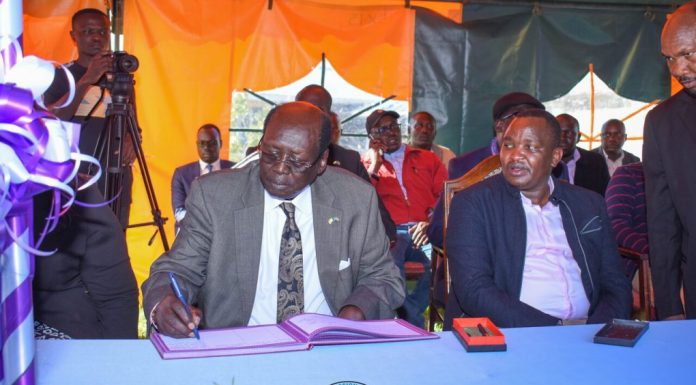 Baringo-based hospital to reap big for rescuing President Salva Kiir Barnabas Benjamin, Minister for Presidential Affairs of the Republic of South Sudan, signing the visitors book after leading a delegation to visit the health facility for rescuing President Salva Kiir's life three decades ago. Beside him is Felix Kimwok Baringo County Deputy Governor. PHOTO/Mercy Mission Hospital (MMH).