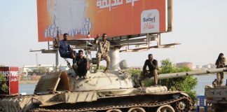Sudan Crisis: Putting the Army-RSF conflict into perspective Red Sea city of Port Sudan; Sudanese army soldiers loyal to the army chief Abdel Fattah al-Burhan sitting on a tank on April 20, 2023. The citizens are bearing the brunt of the conflict. PHOTO/AFP Via Getty Images.