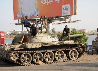 Sudan Crisis: Putting the Army-RSF conflict into perspective Red Sea city of Port Sudan; Sudanese army soldiers loyal to the army chief Abdel Fattah al-Burhan sitting on a tank on April 20, 2023. The citizens are bearing the brunt of the conflict. PHOTO/AFP Via Getty Images.