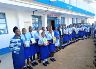 Tombe Girls High School raising the bar of excellence Top students showcase their revision books after getting awarded. With them are Mrs. Rebecca Ondicho (in front), Deputy Principal Administration, Mrs. Jane Nyanumba, Principal (center), BoM Chair, Dr. Charles Nyandusi (next to principal) and a teacher (far end). PHOTO/Tombe Girls.