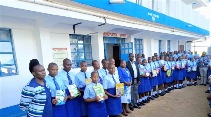 Tombe Girls High School raising the bar of excellence Top students showcase their revision books after getting awarded. With them are Mrs. Rebecca Ondicho (in front), Deputy Principal Administration, Mrs. Jane Nyanumba, Principal (center), BoM Chair, Dr. Charles Nyandusi (next to principal) and a teacher (far end). PHOTO/Tombe Girls.