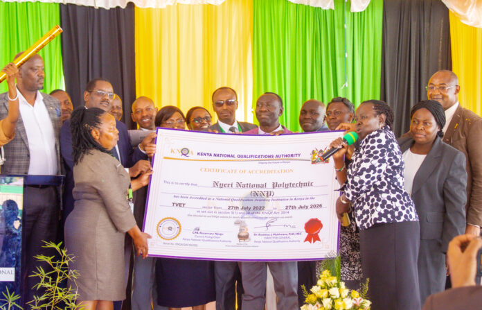 Nyeri National Polytechnic Chief Principal David Mwangi, Esther Mworia, PS TVETS, representatives from KNQA and other invited guests pose for a photo with the Certificate of Accreditation awarded to the polytechnic during the launch of CBS Curriculum on May 12, 2023. PHOTO/Courtesy.
