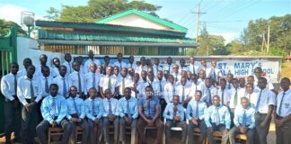George Onyango, newly-crowned Chief Principal steering St. Mary’s Ukwala Student Council body of St. Mary's Ukwala High School pose for a photo at the main gate. Photo/Bonface Otieno, Scholar Media Africa.