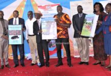 From left: Dr. Peter Mose, Prof. John Akama, Dr. Evans Mecha, Mzee Peter Getenga, Dr. Peter Otieno, Prof. Nicolas Makana, Dr. Marion Onyambu and Dr. Prisca Tanui hold their two books and a dictionary during the launch on May 31, 2023 at Kisii University. PHOTO/Boaz Khuteka, Scholar Media Africa.