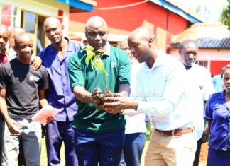 NEMA keen to make Cardinal Otunga a model school curbing climate change Albert Ombiro (in green T-Shirt), Chief Principal Cardinal Otunga High, leads teachers and students in a tree planting session at the school's grounds on July 17, 2023. The event was led by NEMA. PHOTO/Nehemiah Josephat, Scholar Media Africa.