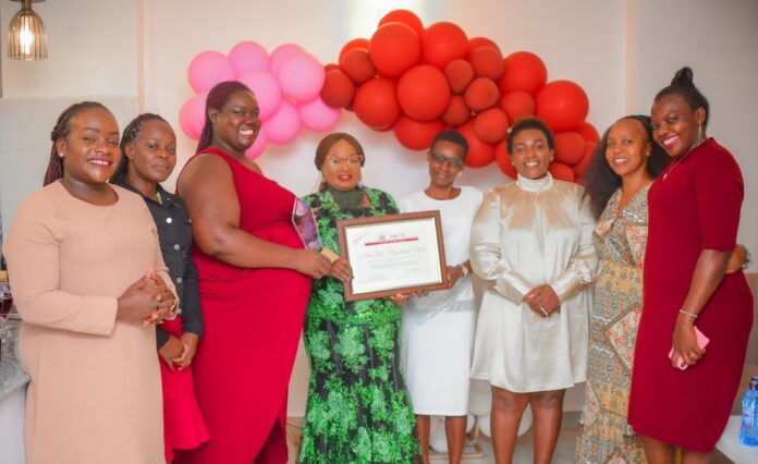 Magdalene Mwebi alias St. Jude (fourth left), a transformational woman leader with an impactful track record in community service, advocacy, leadership development and entrepreneurship, holds her award on July 30, 2023, alongside other women leaders after they presented it to her in a warm event in Kisii town. She had been honored with it earlier during the Women Empowering Women Conference in Nairobi. PHOTO/ Mzii Photography.