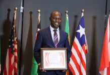 Amb. Dominic Obadiah, a change agent who has been advocating for peace, humanitarian diplomacy, mental health and civility, holding his 2022 National Leader Award by Mental Real-Of-State, an organization by Michael Freeland. He has bagged myriad awards in his journey towards changing the world. PHOTO/Courtesy.