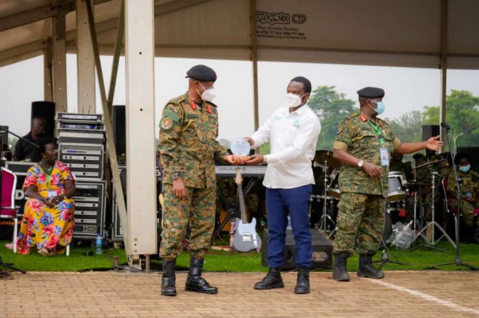Dr. Jibril Ssemakula, a professional clinician and Founder, Million Trees International Organisation, receiving an appreciation award from the UPDF CDF Gen Wilson Mbadi in February 2023. The entity has been on a mission to plant as many trees in Uganda and restore forest cover. PHOTO/MTIO.