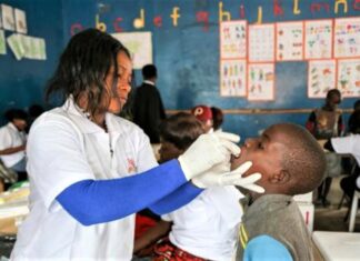 Zambia’s Cholera Crisis: Groping for health, governance, and resilience A health specialist attends to a pupil in Zambia as efforts to combat the ongoing cholera outbreak gain weight. The government, with support from WHO, has embarked on administration of vaccines in order to contain the crisis. PHOTO/MSF.