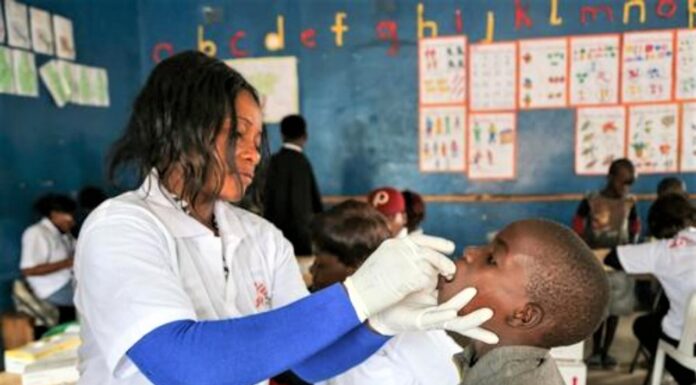 Zambia’s Cholera Crisis: Groping for health, governance, and resilience A health specialist attends to a pupil in Zambia as efforts to combat the ongoing cholera outbreak gain weight. The government, with support from WHO, has embarked on administration of vaccines in order to contain the crisis. PHOTO/MSF.