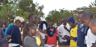 Toroitich Yegon’s relentless pursuit of success Patrick Yegon (next to the lady in specs) engaging with students in his mentorship and book tour at GG Rumuruti Boys High School. PHOTO/Janet Kiriswo, Scholar Media Africa.